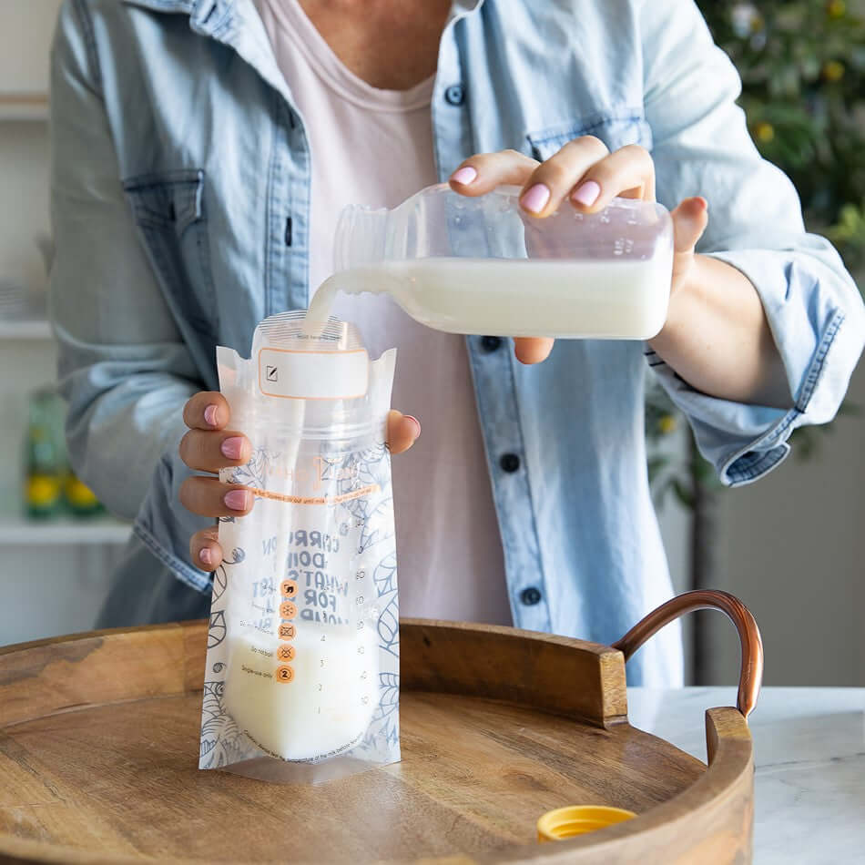 expressed breast milk in plastic breast milk storage bag pouring breastmilk