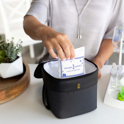 mom placing the jamie reusable ice packs in the designated pocket of roxwell cooler bag