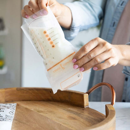 mom demonstrating the leakproof feature of idaho jones breastmilk storage bag