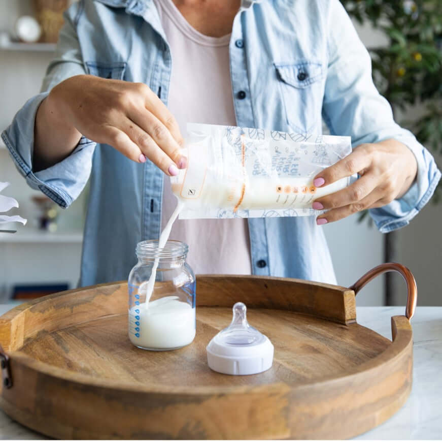 mom showing how easy to pour the pumped milk from the idaho jones breastmilk storage bag to the baby bottle