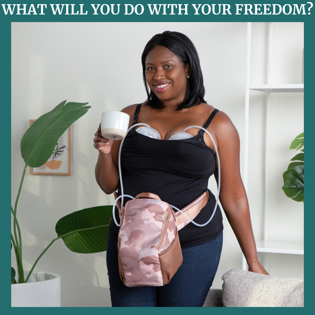 Woman holding a cup and wearing the camouflage-patterned belt bag while pumping in a home setting with plants and shelves.