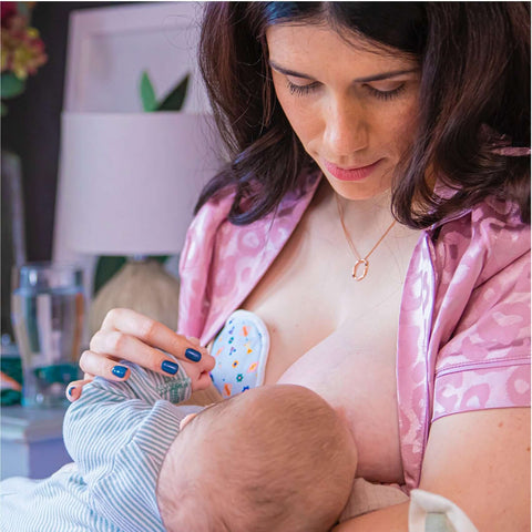 Image of mom nursing on one side while using the Idaho Jones reusable nursing pads on the other to catch leaks