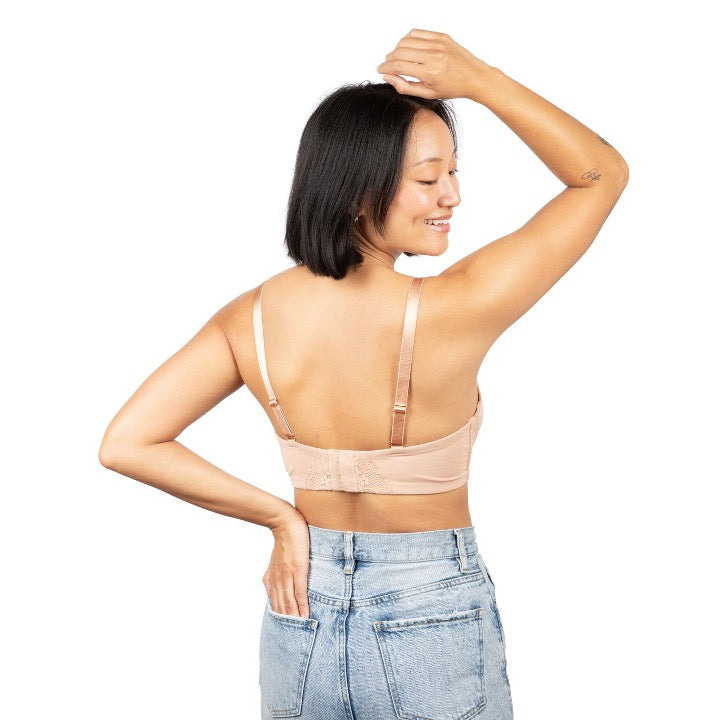 mom posed on her back while wearing the tuscany aine pumping bra featuring its adjustable strap and seam free hook and eye