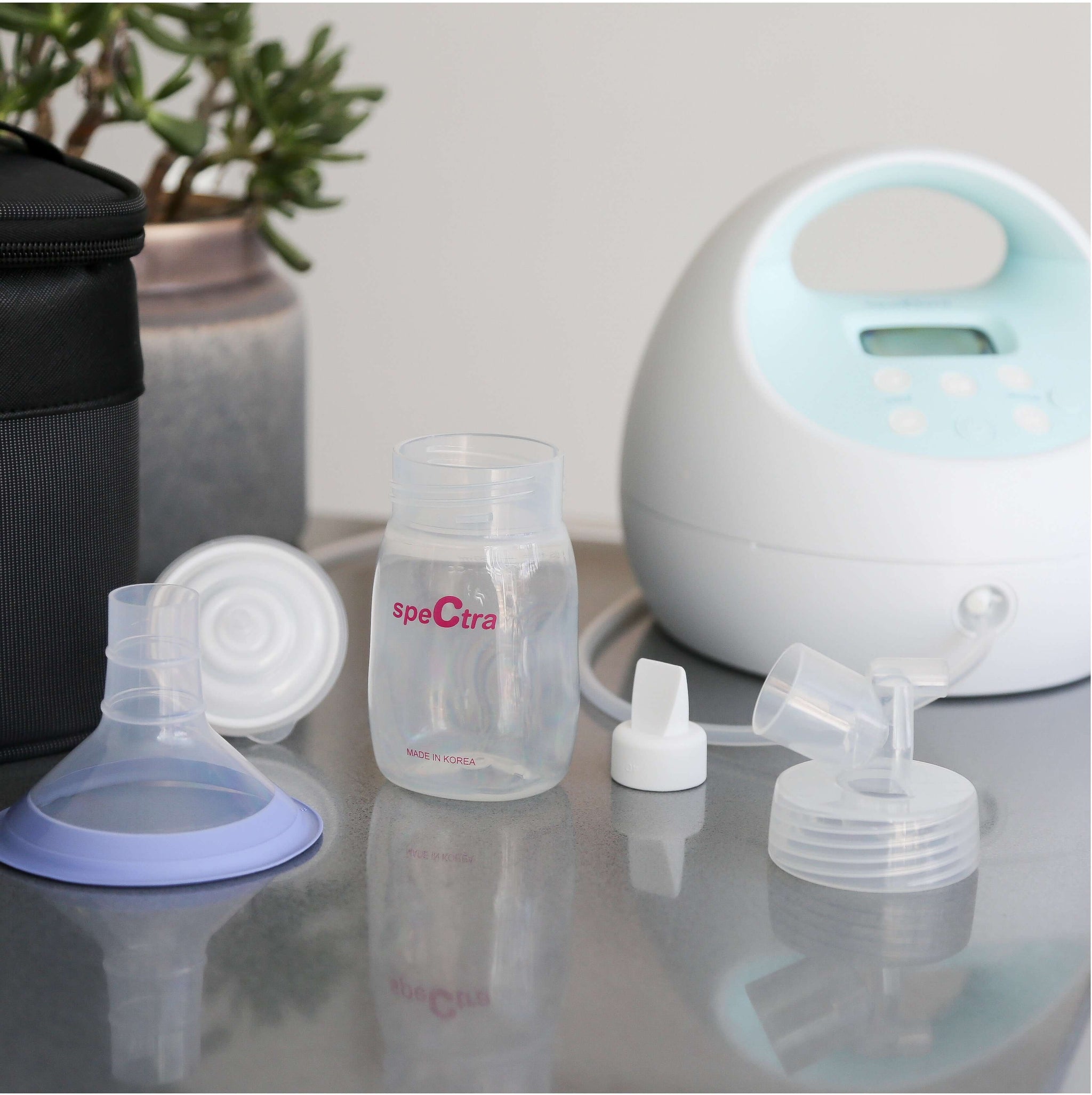 spectra pump parts including a flange adapter, bottle, and pump for enhancing breastfeeding experience.