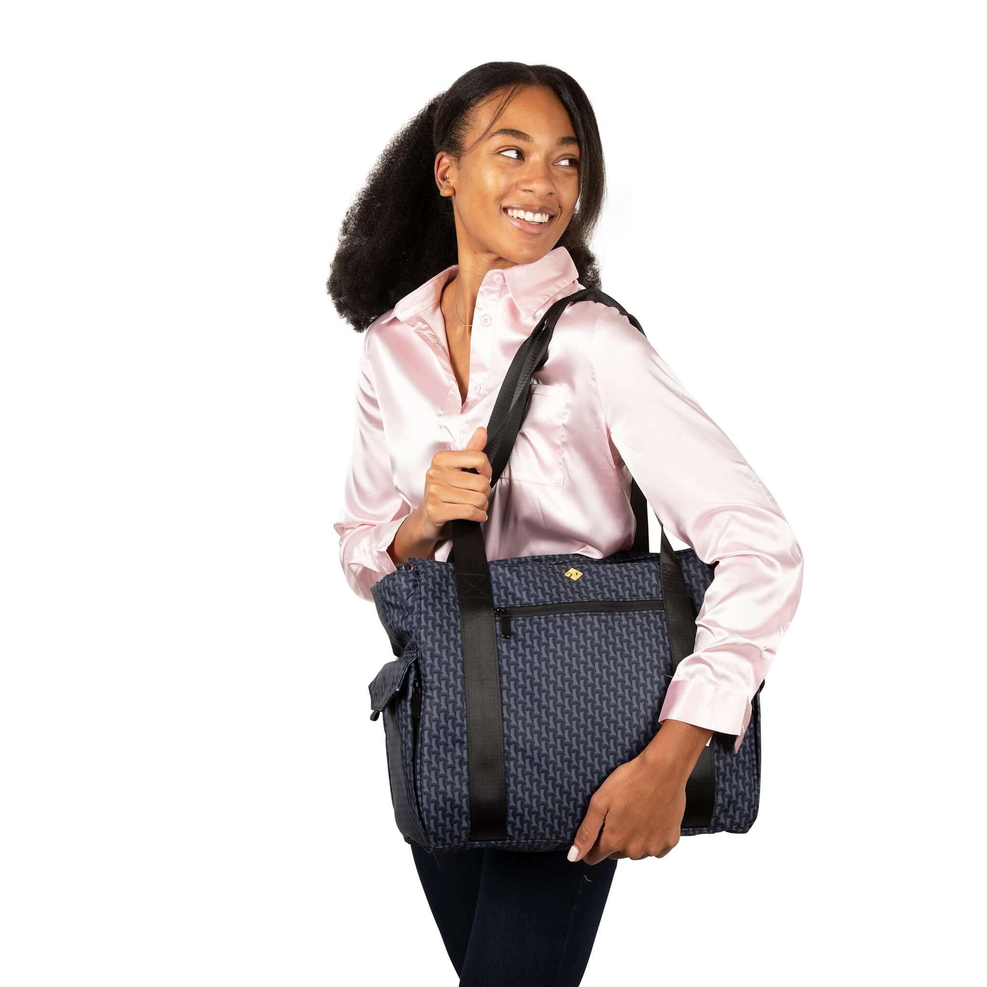 Mom smiles as she carries the ellerby tote bag over her shoulder.