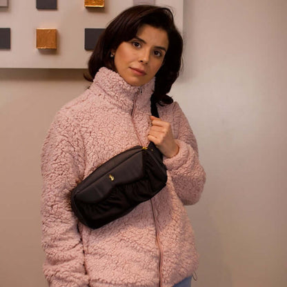 content mom carrying the pump-a-porter mini wearable breast pump bag as sling bag