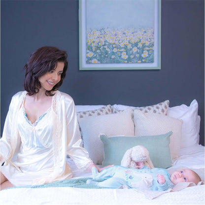 Mom happily caring for her child while wearing the instarelief breast therapy pack to ease engorgement and mastitis.