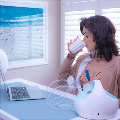 Mom works comfortably while pumping with an instarelief breast therapy pack without distress